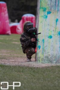 woman and boy hiding during paintball game