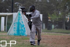 man shooting paintball